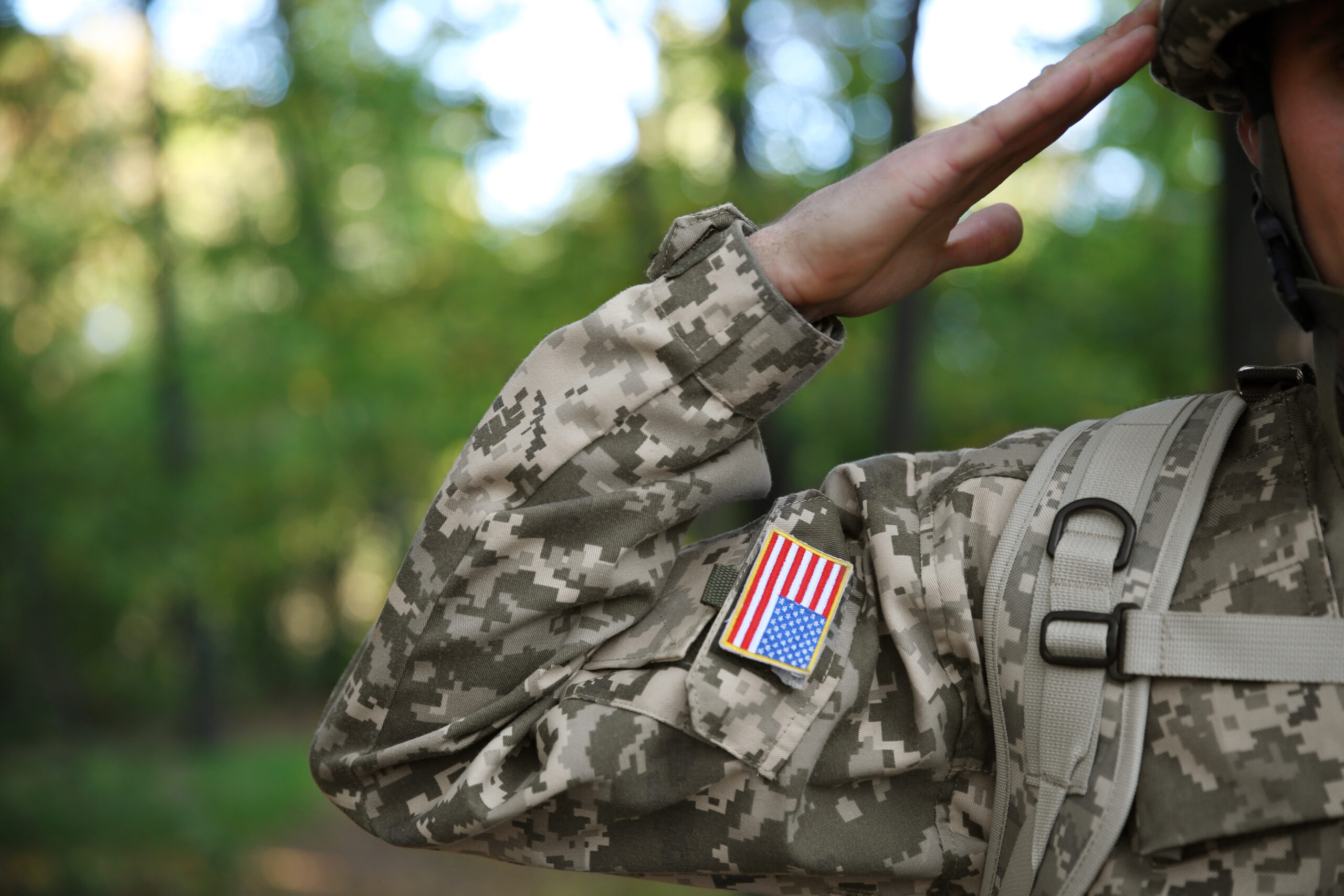 Soldier in camouflage taking salute, close up view veteran