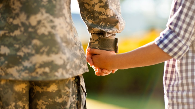military dad and son hold hands